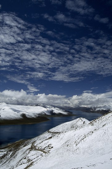 CHINA, Tibet, Yamdrok Tso, "The Turquoise Lake, with snow covered hills, seen from the summit of the Khamba La."