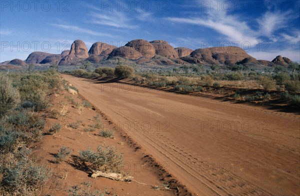 AUSTRALIA, Northern Territory, Uluru National Park, "A dirt road through the park, with Katatjuta, The Olgas, in the background."