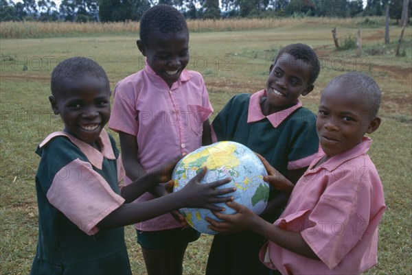 KENYA, Education, Schoolchildren holding a globe.