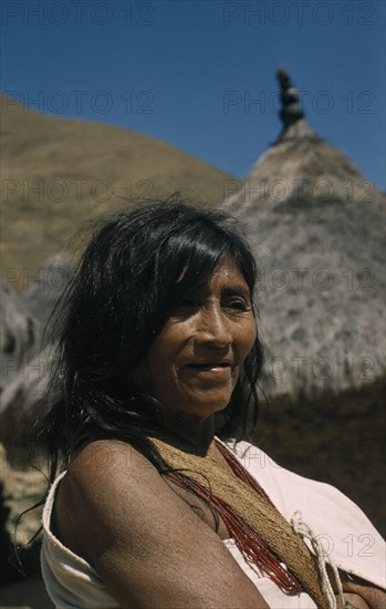 COLOMBIA, Sierra Nevada de Santa Marta, Kogi Tribe, Portrait of older woman wearing necklace of precious red glass beads.