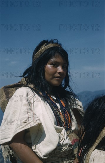 COLOMBIA, Sierra Nevada de Santa Marta, Ika Tribe, "Portrait of young woman with woven cotton manta / cloak, coloured glass bead necklace and “fique” / cactus fibre carrying bags"