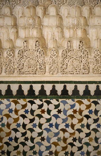 SPAIN, Andalucia, Granada, The Alhambra.  Detail of stucco and tiles