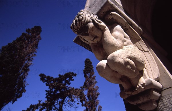 CROATIA, Dalmatia, Brac, "Supetar Petrinovic mausoleum/sculpted angel. Toma Rosandic, contemporary of the great Croatia sculptor Ivan Mestrovic, fashioned this sublime mausoleum for the local Petrinovic family which lies in the town cemetary on the wooden cape of Saint Nicholas just outside Supetar"