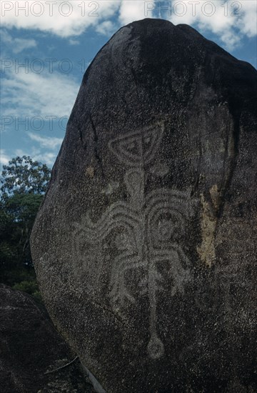 COLOMBIA, Vaupes Region, Tukano Tribe, "Tukano deity “NI” – the river God, engraved hundreds of years ago on this very hard granite boulder in the rio Piraparana"