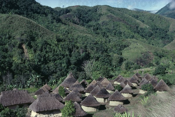 COLOMBIA, Sierra Nevada de Santa Marta, Southern foothills of the Sierra, "Chendukua. Traditional old Kogi village of circular mud walled and grass-thatched  households surrounded by semi-tropical cultivation plots mainly plantains coffee yucca/manioc and maize,  hillsides often denuded of trees due to previous over-cultivation/grazing.  "