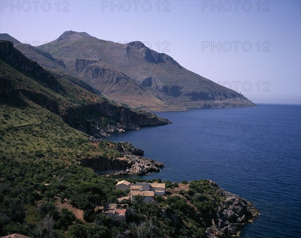 ITALY, Sicily, North West Penninsula, "Nature Reserve of Zingaro. View along the Eastern side, coastal town with Mount Acci in the background"