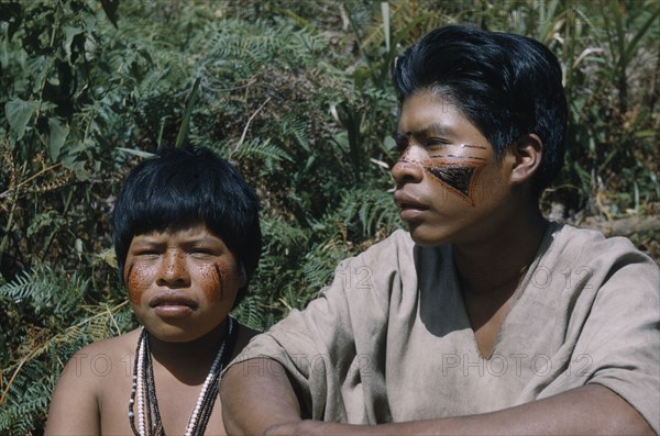 COLOMBIA, Sierra de Perija, Yuko - Motilon , Gabriel and his wife with bright red “Achiote” facial paint extracted from ground Achiote seeds and black fungal facial paint.