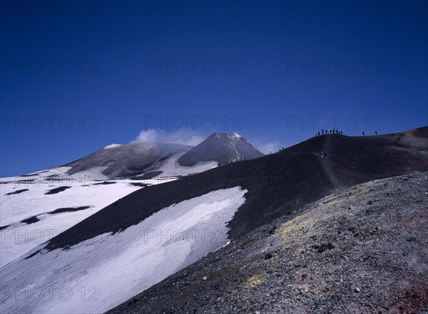 ITALY, Sicily, Mount Etna, Visitors viewing the main summit cone on the South side of the volcano.