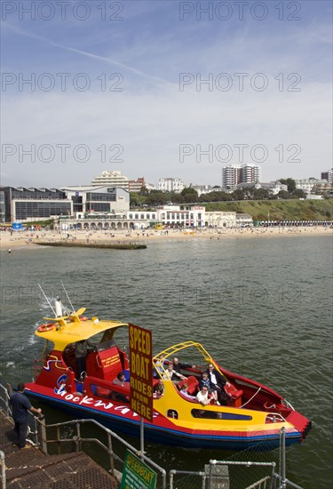 ENGLAND, Dorset, Bournemouth, Speed Boat ride from the Pier with The East Beach and the Imax Complex on the left beside seafront restaurants and bars. Tourists enjoy the sandy beach.