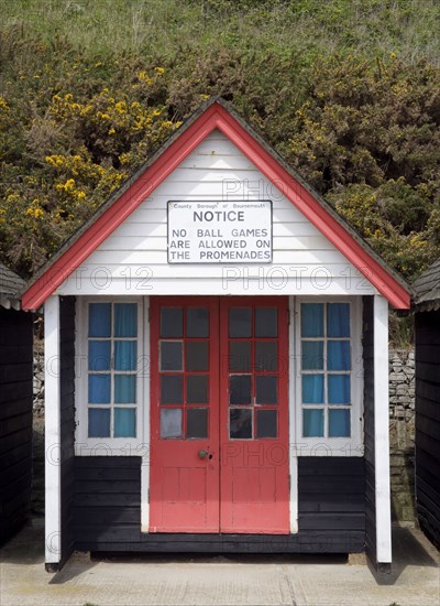 ENGLAND, Dorset, Bournemouth, Beach hut on The East Beach with a sign saying that no ball games are to be playe