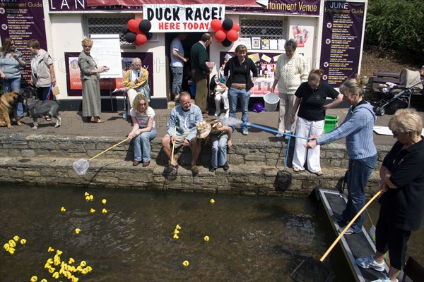 ENGLAND, Dorset, Bournemouth, Traditional Duck Race in The Lower Pleasure Gardens with tourists watching and participating