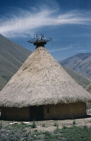 COLOMBIA, Sierra Nevada de Santa Marta, Kogi Tribe, "Kasiquial, a ritual meeting centre for Kogi “mamas”  / priests. Sacred potsherds in rack at apex of conical thatched roof indicate this is a nuhue / temple."