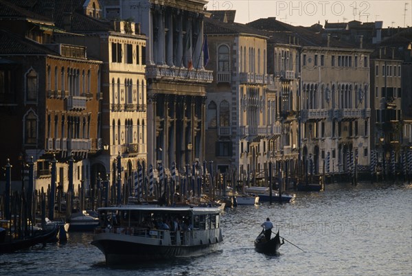 ITALY, Veneto, Venice, Crowded vaporetto or waterbus and gondola on the Grand Canal near Rialto Bridge.