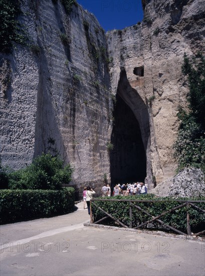ITALY, Sicily, Siracuse, "Latomie stone quarries caves, also used for prisons. Tourists at the entrance to The Ear of Dionysius, Orecchio di Dionisio"