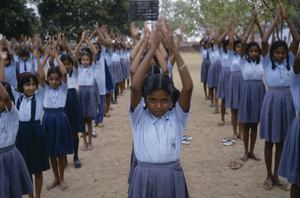 INDIA, Andhra Pradesh, Education, Primary school children starting day with physical exercise.