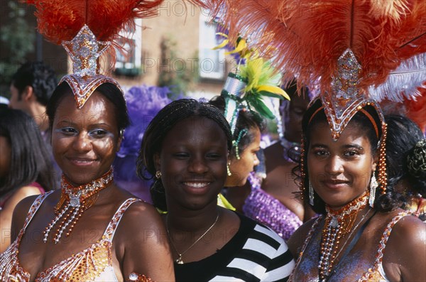 ENGLAND, London, Notting Hill carnival three women revellers.