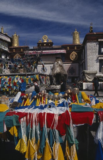 CHINA, Tibet, Lhasa, Prayer wheels and other religious paraphernalia for sale in front of the Jokhang Temple