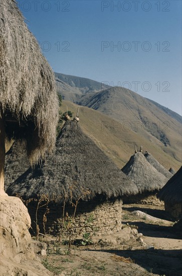 COLOMBIA, Sierra Nevada de Santa Marta, Kogi Tribe, "Grass thatched dwellings of San Miguel, with sacred pots at roof apices "