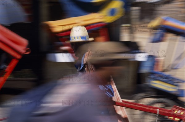 MADAGASCAR, Antsirabe, Rickshaw drivers in motion blur