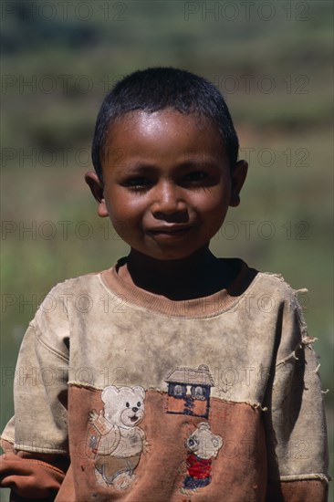 MADAGASCAR, People, Children, Portrait of a young boy wearing a dirty shirt printed with teddy bears
