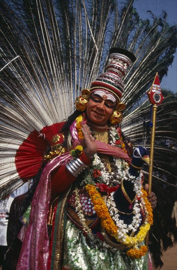 INDIA, Kerala, Thrissur, "Mayura Nritham, Peacock Dance, dancer in costume and painted face, at The Great Elephant March festival."