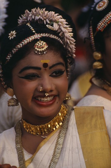 INDIA, Kerala, Thiruvananthapuram, "Mohiniyattam dancer at The Great Elephant March festival. Hair decoration, earrings and nose rings."