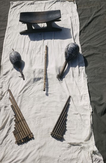 COLOMBIA, Vaupes Region, Tukano Tribe, "Tukano musical instruments with a stool used by tribal elders and shamans; engraved maracas, bamboo flute, bamboo panpipes"