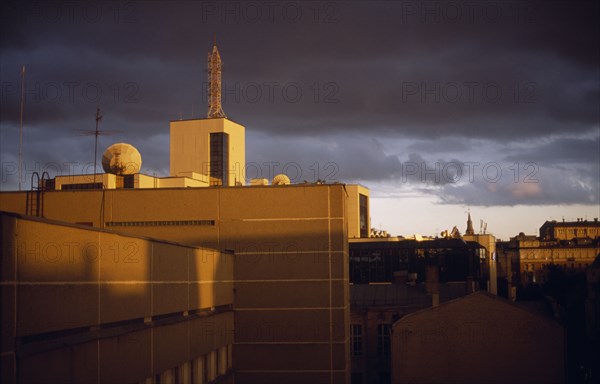 RUSSIA, Moscow, City view of roof tops at sunset with a stormy sky.