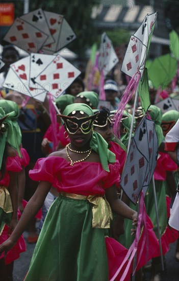 TRINIDAD, Festivals, Carnival precession with girls dressed in pink and green costumes holding large plain card props