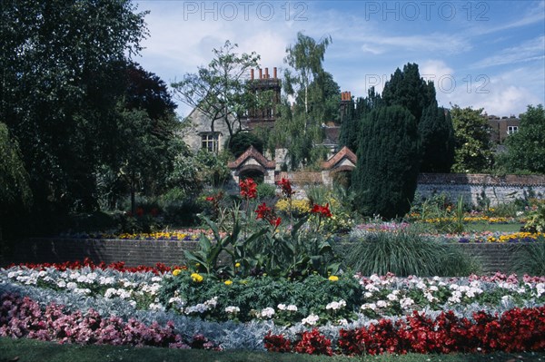 ENGLAND, East Sussex, Lewes, Southover Grange Gardens. View across flower beds towards Elizabethan house