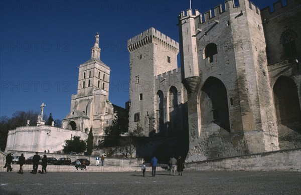 FRANCE, Provence Cote d’Azur, Vaucluse, Avignon.  Palais des Papes and Cathedral Notre Dame des Doms with visitors in courtyard below.