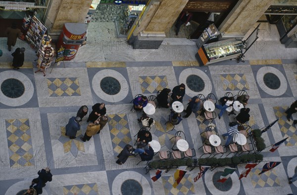 ITALY, Campania, Naples, Looking down on cafe tables inside Galleria Umberto.