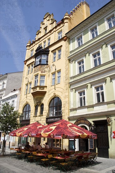 CZECH REPUBLIC, Bohemia, Prague, Tables and umbrellas on the pavement outside a cafe in a sidestreet of the Old Town