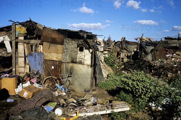 NICARAGUA, Managua Province, Managua, "The 'waste basket of Chureca' has existed since the late 1960's in the Acahualinca district of Managua, Nicaragua. It covers 42 hectares, is bombarded with thousands of tonnes of waste a day and is home to over 170 struggling families. By day over 1500 more Nicaraguans arrive at the site, some of whom are children who have been sent by their parents, others come by their own initiative. All compete with the adults to find, harvest and re-sell recyclable material. Of the minors who go to the waste basket - 88% it has respiratory problems, 62% suffer from parasites and 42% have serious skin diseases. Although the sky is clear and blue the air is thick of burning waste or rotting waste. Little houses or 'casitas' lie in a mixed muddle of rubbish and waste. The house at the front of shot is made up of an eclectic collection of doors, wooden planks, dustbin bags, corrugated iron strips and whatever waste material seems to have been lying around. Proppe...