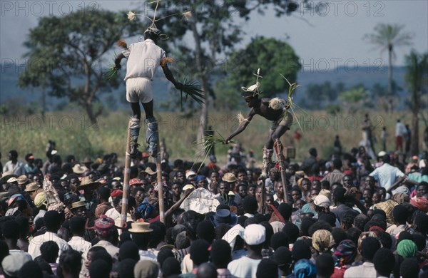 CONGO, Gungu, Bapende stiltwalkers amongst crowd at Gungu festival.