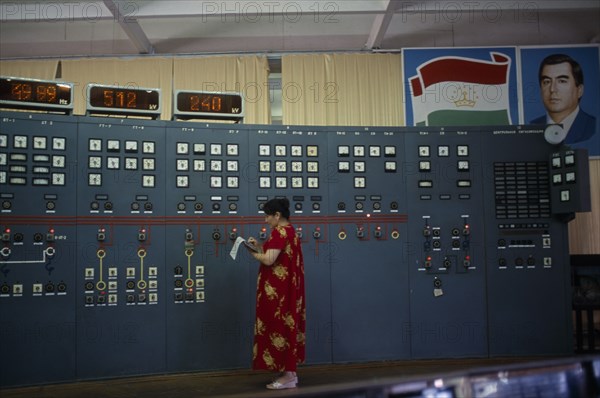 TAJIKISTAN, Nurek, "The main hall of the hydroelectric power station, a woman taking readings from the control panel."