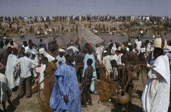 NIGERIA, North, Argungu, Crowds of spectators and competitors in annual three day fishing festival in which giwan ruwa fish are caught with hand nets and calabashes.