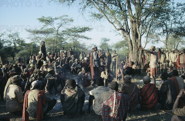 UGANDA, Karamoja District, "Dodoth  Karamojong warriors and elders at meeting to discuss potential attack by enemy tribe,  The elders can assert power and influence over younger men."