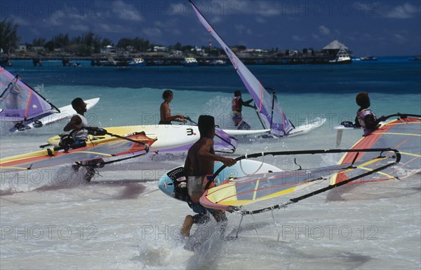 BARBADOS, Christchurch, Oistins,  Windsurfers racing into the sea