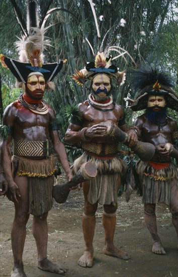 PACIFIC ISLANDS, Melanesia, Papua New Guinea, Southern Highlands.Tari. Huli Tribemen in traditional costumes with face paint and elaborate feather headdresses for Sing sing Festival.