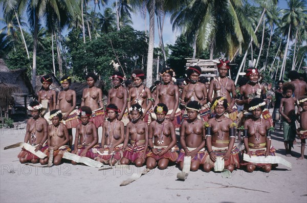 PACIFIC ISLANDS, Melanesia, Trobriand Islands, Kaileuna Island. Female dancers in costume greeting visitors