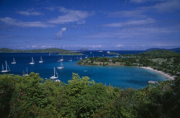 DOMINICA, Landscape, Elevated view over beach and coastline with tree covered Islands and bays on the Atlantic with yachts on the water