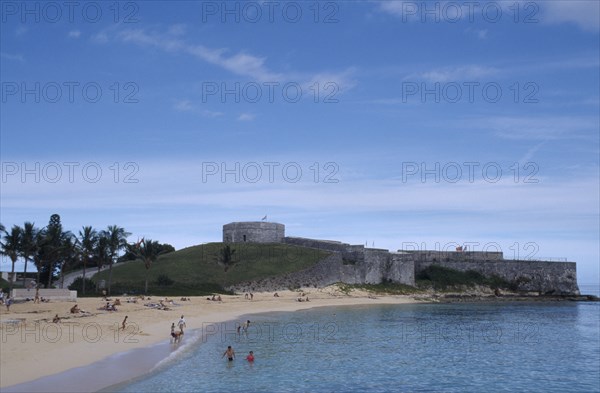 BERMUDA, St George Parish, Fort St Catherine behind St Catherines Beach with people on the sand and in the sea