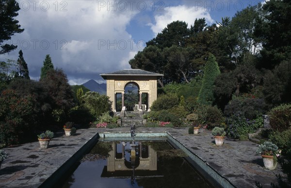 IRELAND, County Cork, Bantry Bay, Ilnacullin Garinish Island. The Italian Garden with view across a pond