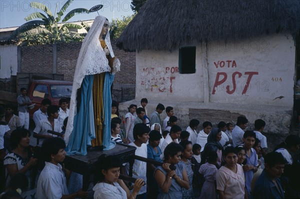 MEXICO, Oaxaca, Santiago Pinotepa Nacional, Statue of the Virgin Mary is carried through street during Easter procession.