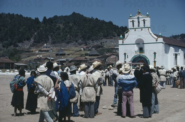 MEXICO, Chiapas, San Juan Chamula, Crowd gathered in square outside church in village where both Catholic and indigenous Mayan beliefs and traditions are followed.