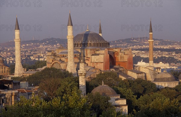 TURKEY, Istanbul, Dome and minarets of Haghia Sophia amongst rooftops of the Sultanahmet.  Former mosque now museum.