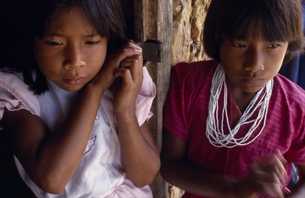 COLOMBIA, Amazonas, Santa Isabel, "Two young Macuna Indian girls, one wearing highly prized white beads as necklace."