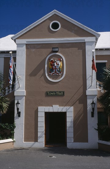 BERMUDA, St George, Kings Square. Town Hall exterior with crest above door  entrance and flagpoles either side