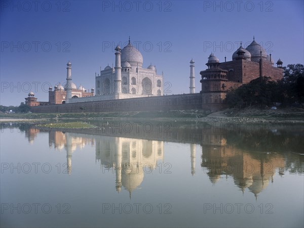 INDIA, Utter Pradesh, Agra, The Taj Mahal seen from across the Yamuna River with its reflection across the water
